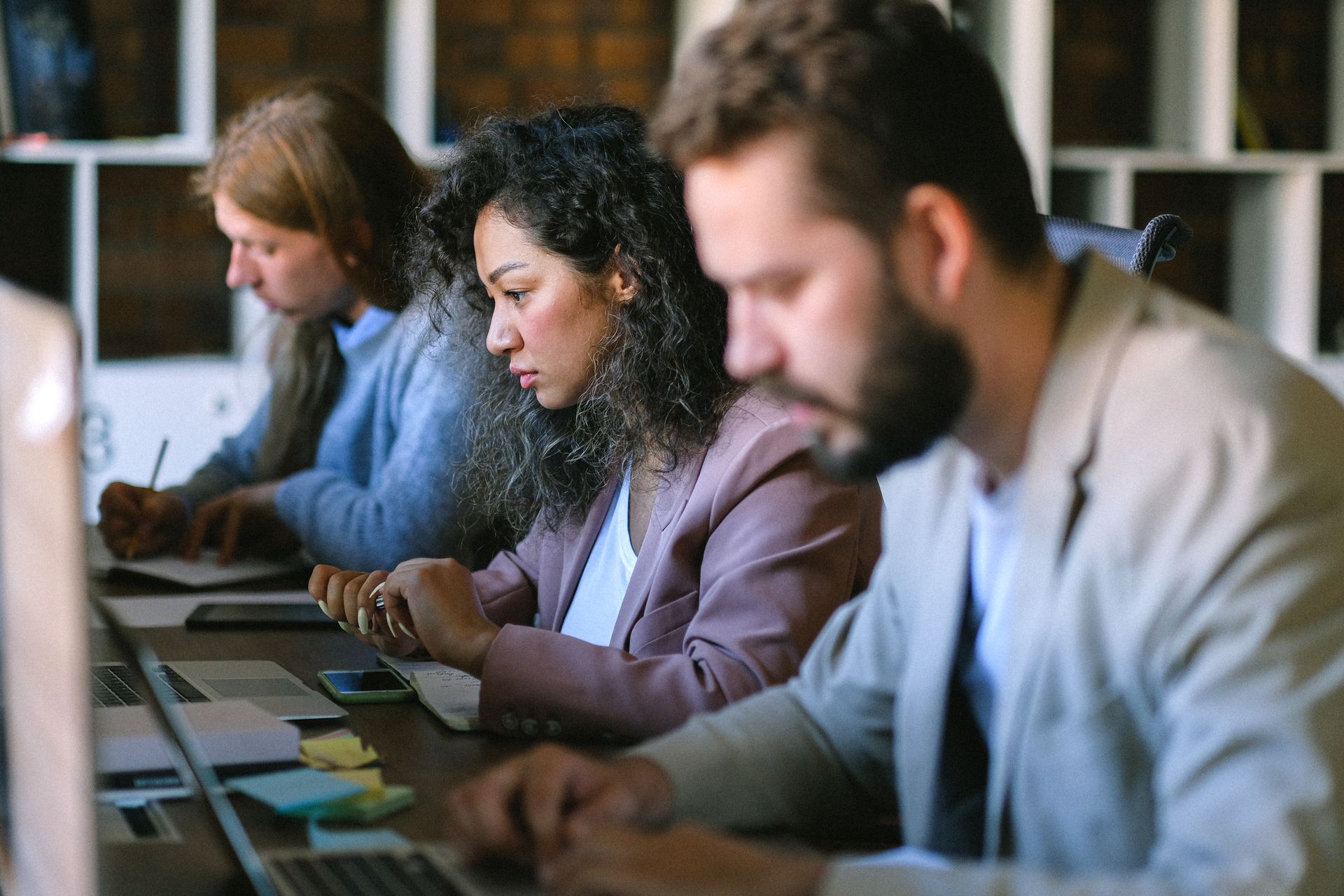 Game developers working together on laptops in a studio