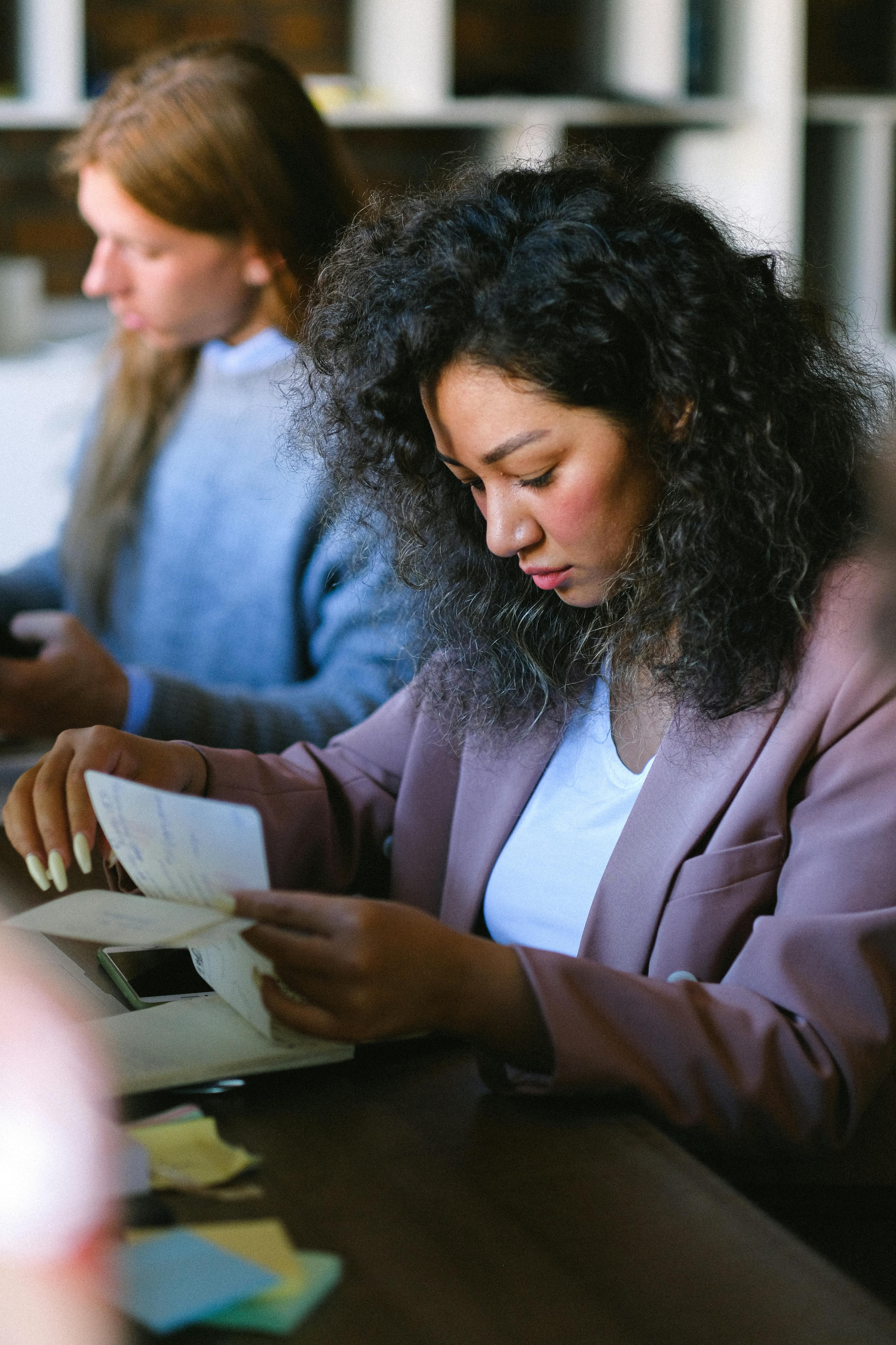 serious woman looking through documents in office