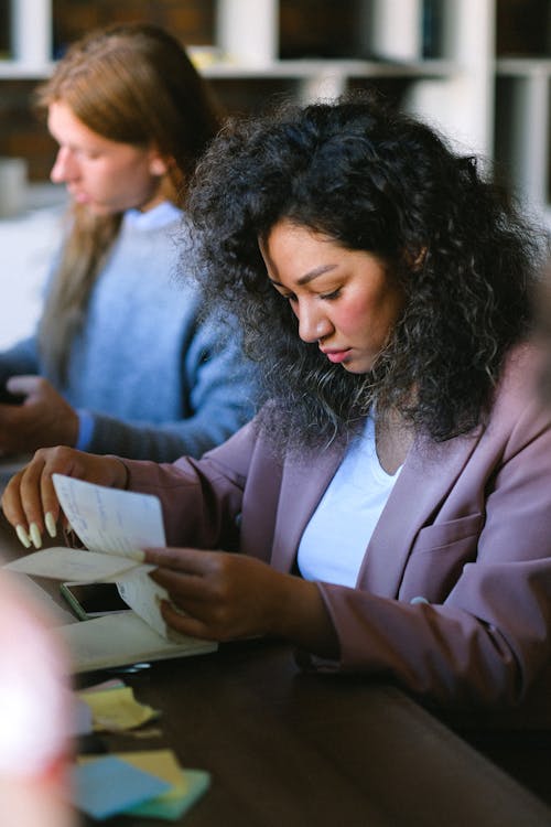 Serious woman looking through documents in office