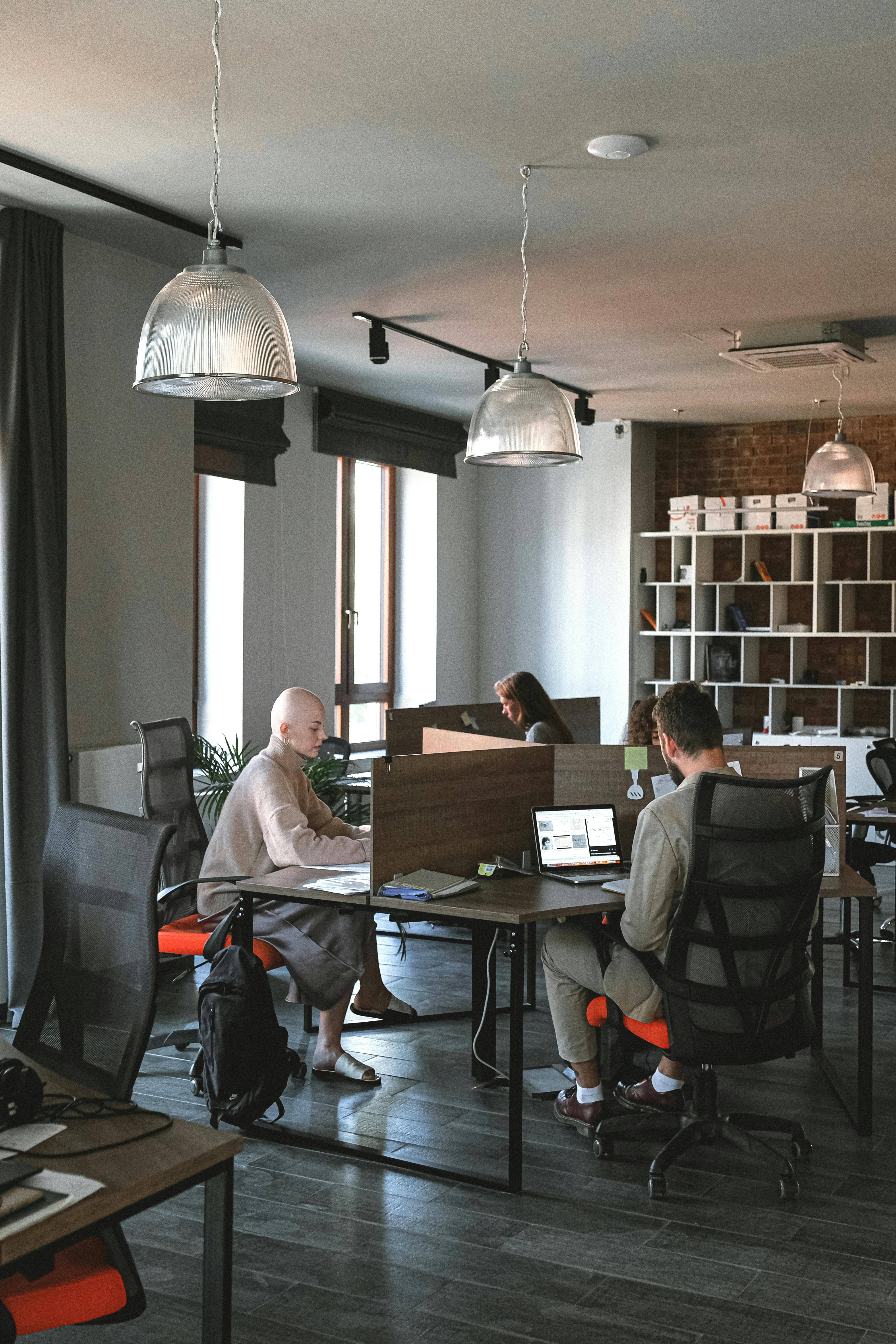 group of colleagues working in office space with gadgets