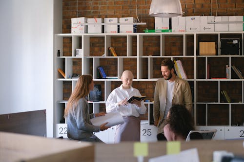 Free Group of focused coworkers having meeting for discussing work plans and projects in open space Stock Photo