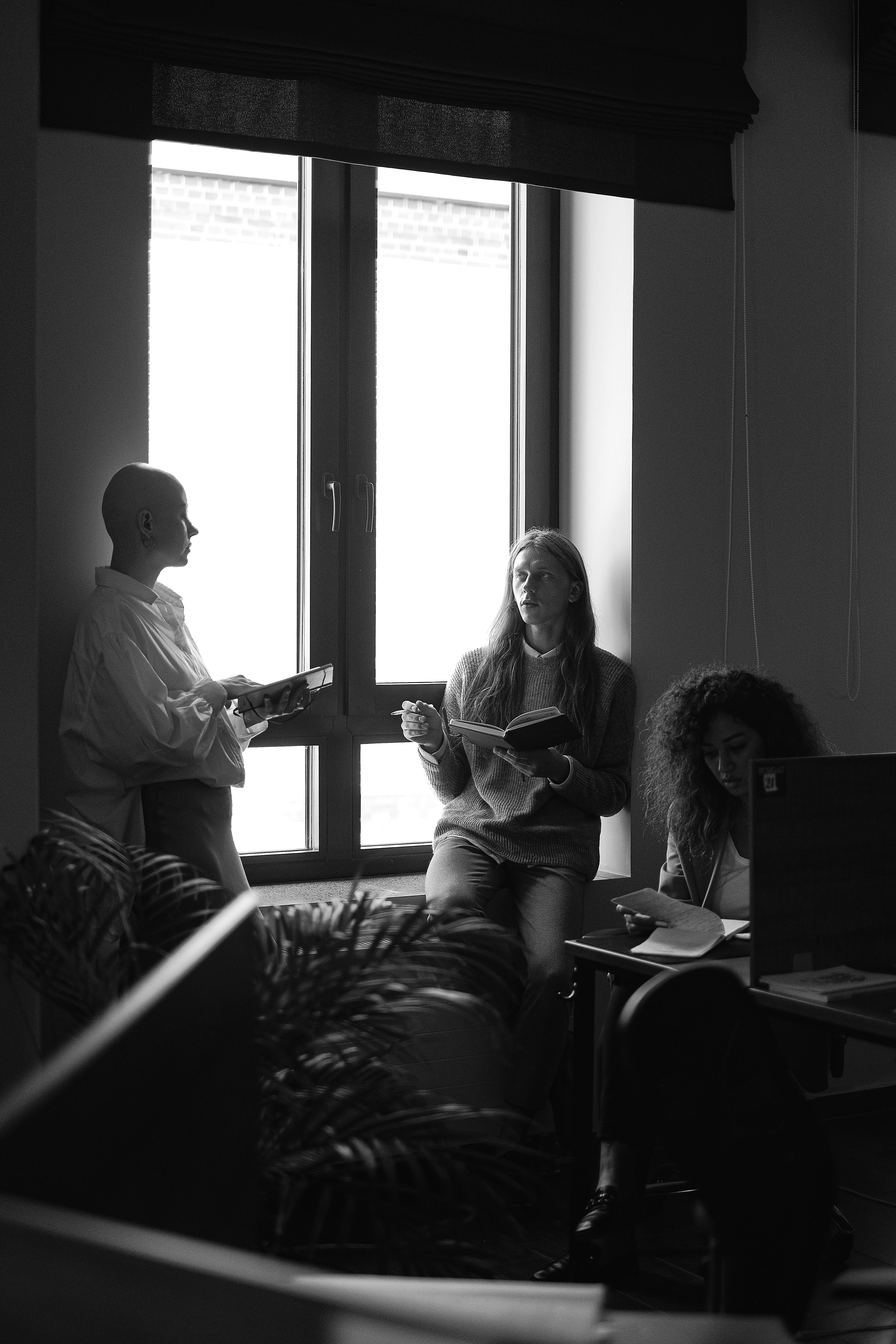 colleagues discussing work in business center