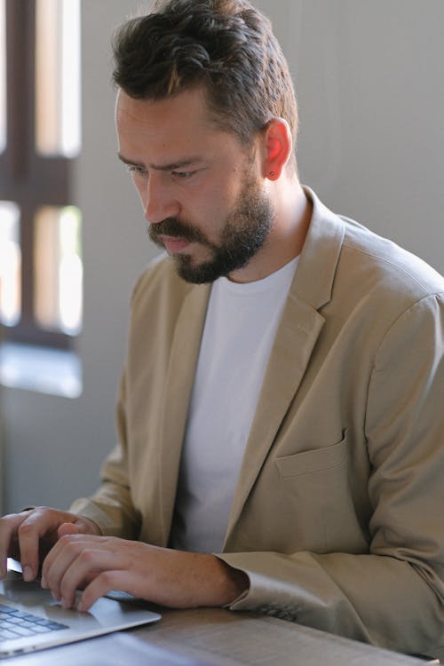 Serious man working on laptop