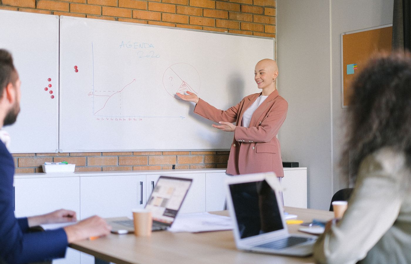 Confident businesswoman leading a presentation on business trends in a modern office.