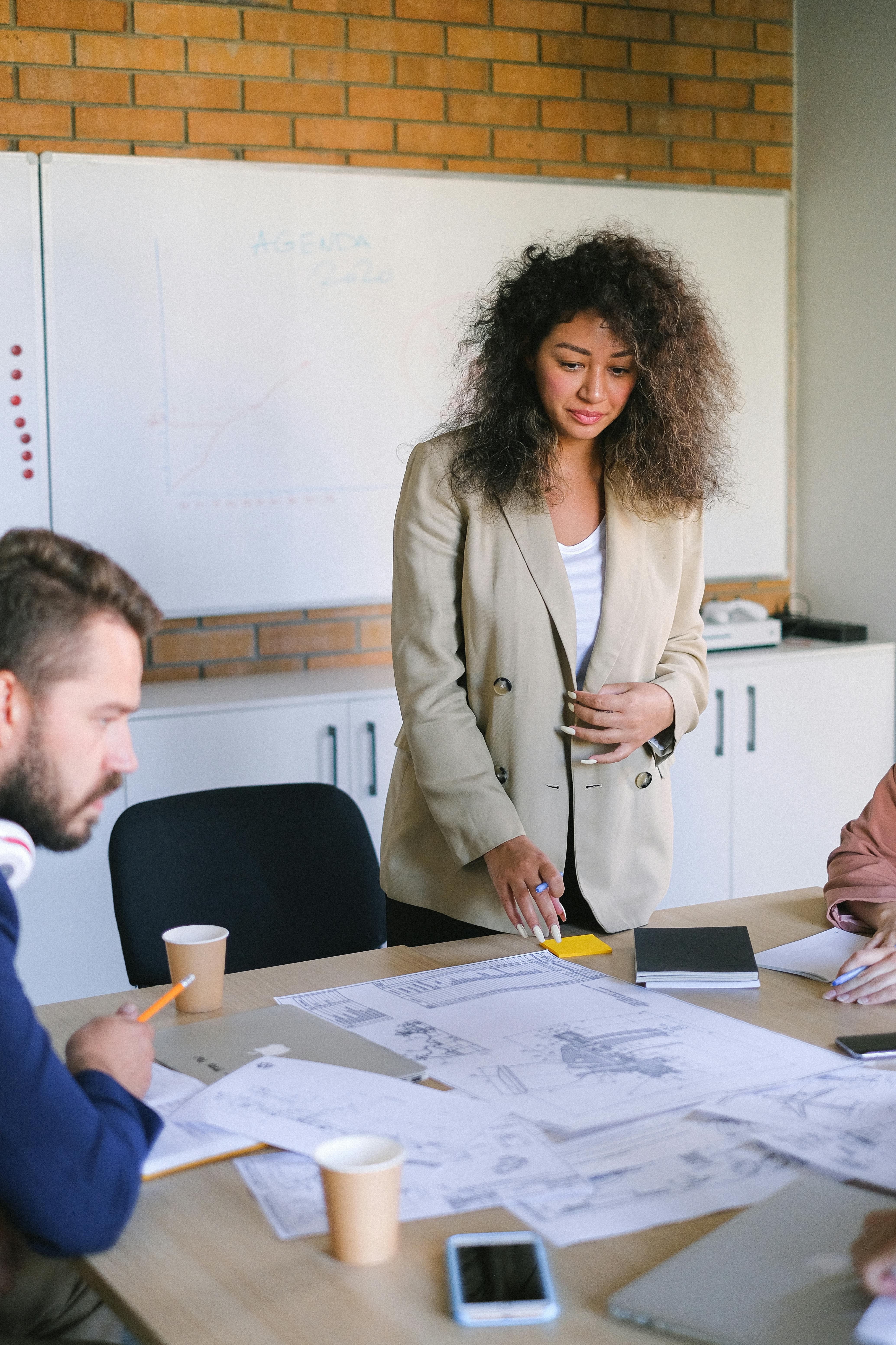 woman at table with documents during meeting with colleagues