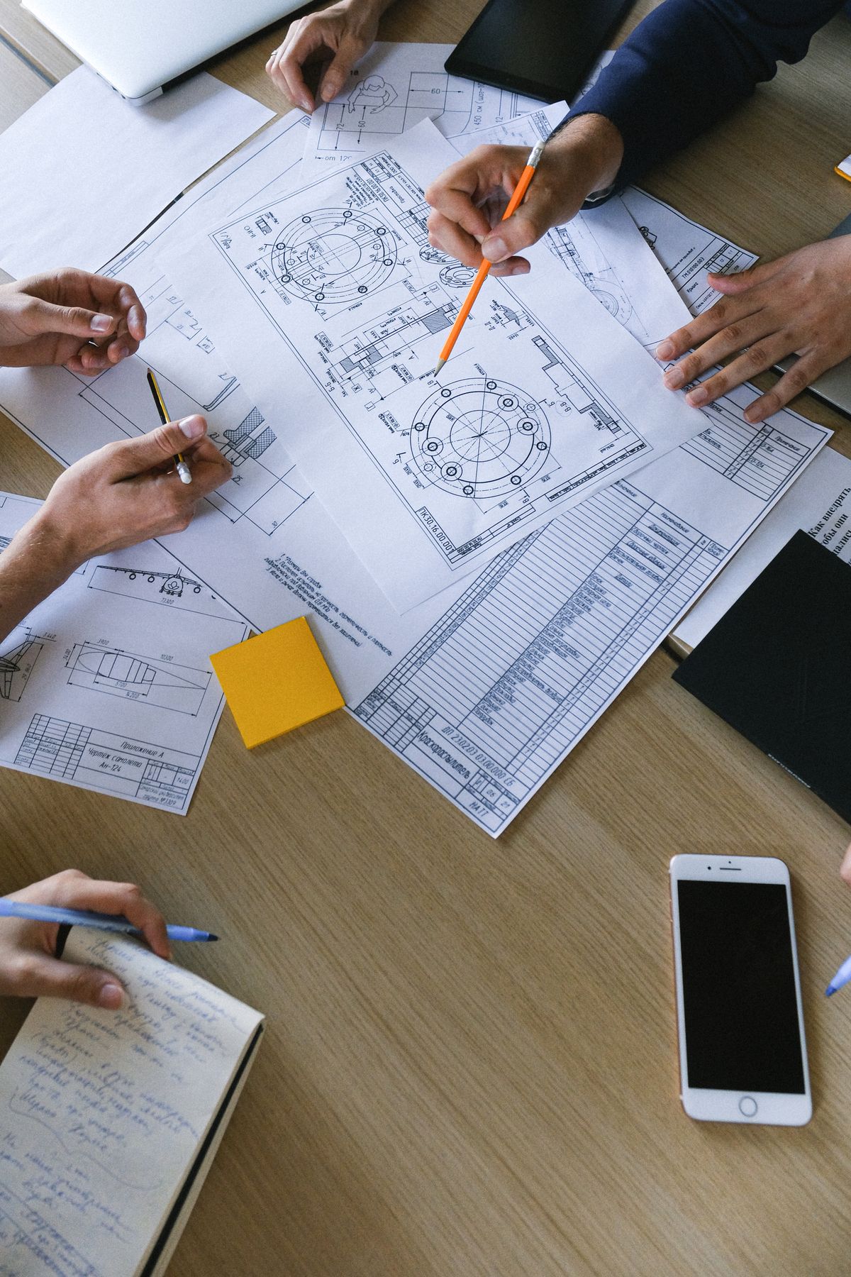 Engineers reviewing plans and documents together on a table