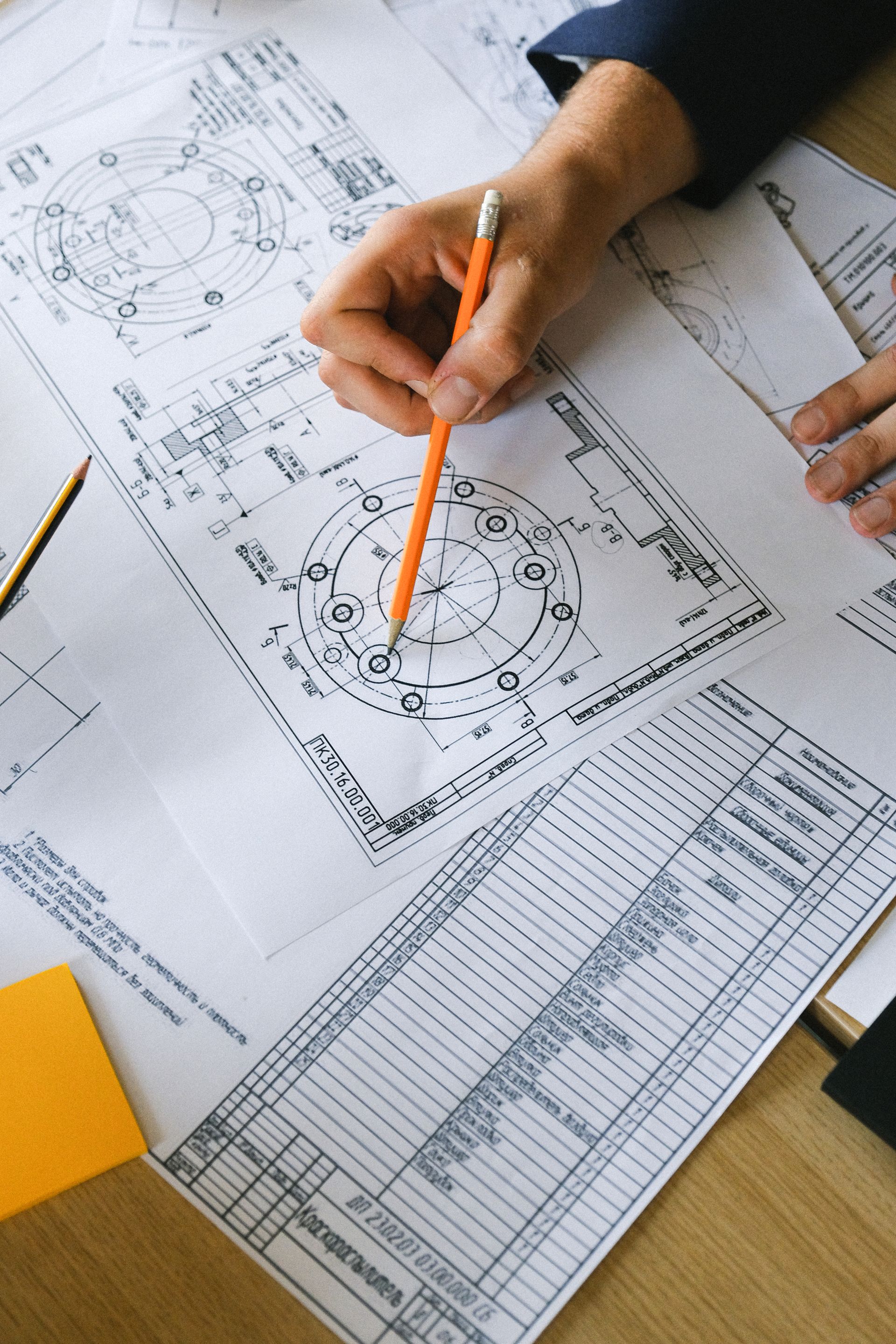 Technical plans being reviewed at a desk