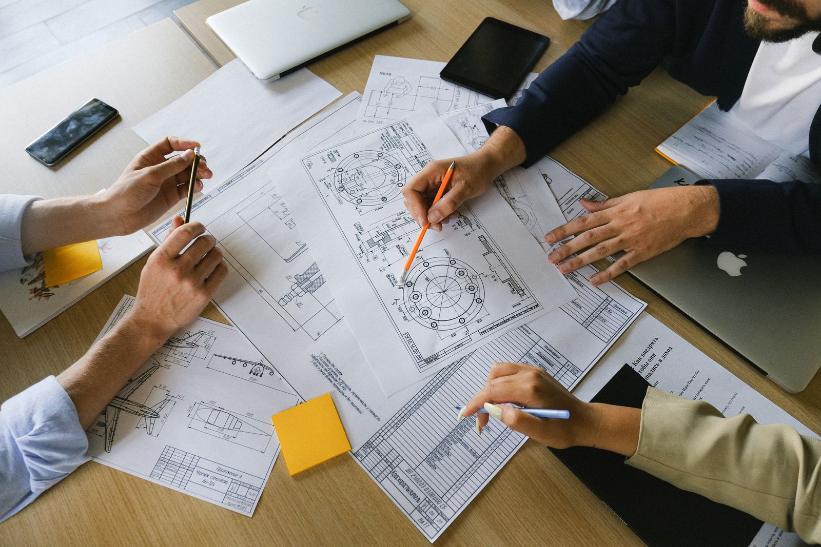 A team reviewing detailed technical plans together before making a decision.