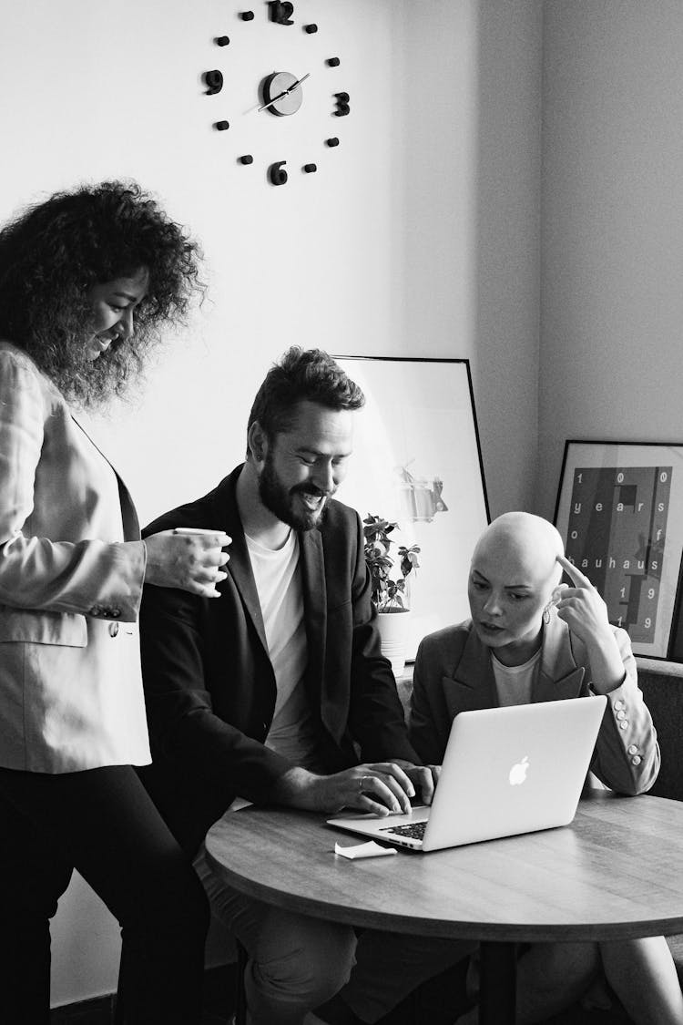 Cheerful Business Colleagues Working On Project On Laptop