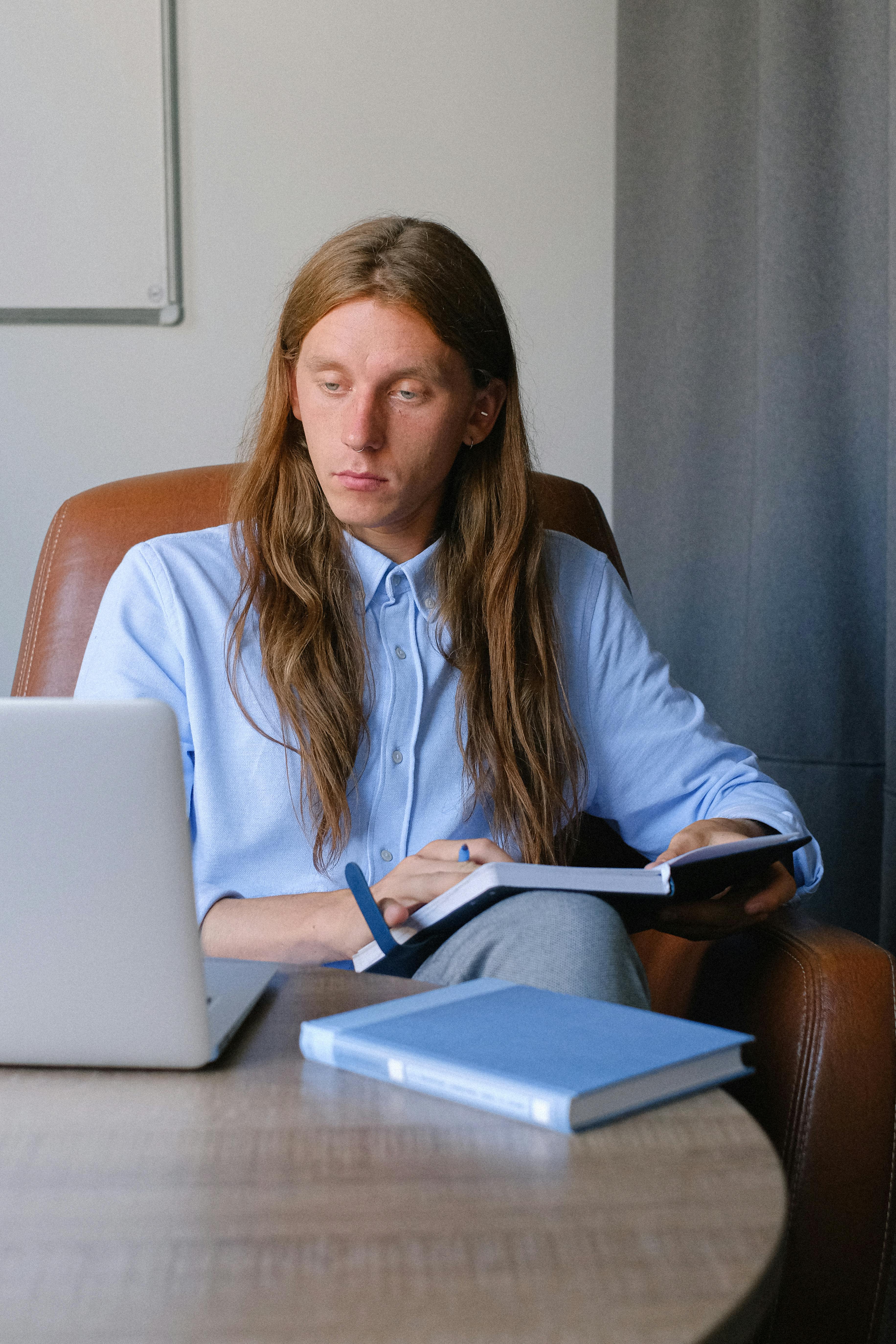 young businessman with planner working at table with laptop