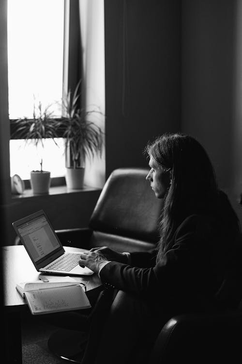 Concentrated entrepreneur working on netbook in workspace