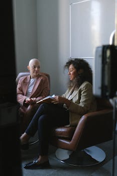 Two businesswomen collaborating in a contemporary meeting setting.
