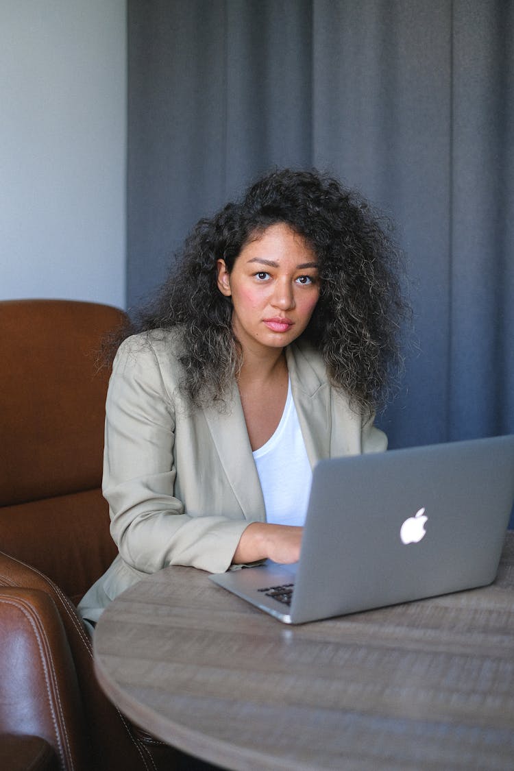 Serious Young Female Entrepreneur Working On Laptop