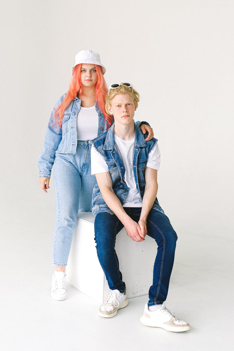 Teenage Man And Woman Embracing Shoulder In Studio