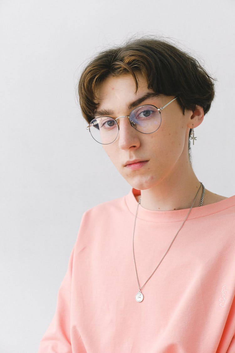 Dreamy Teen Man In Stylish Eyeglasses In Studio