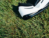 White and Black Vr Headset on Green Grass