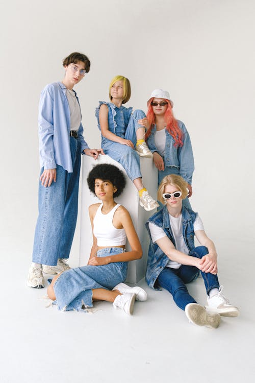 Group of multiethnic models demonstrating casual denim outfits