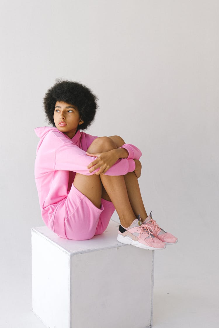 Thoughtful Black Woman With Arms Around Legs