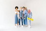 Full body group of teenager friends in jeans wear and glasses with yellow penny board on white background looking at camera