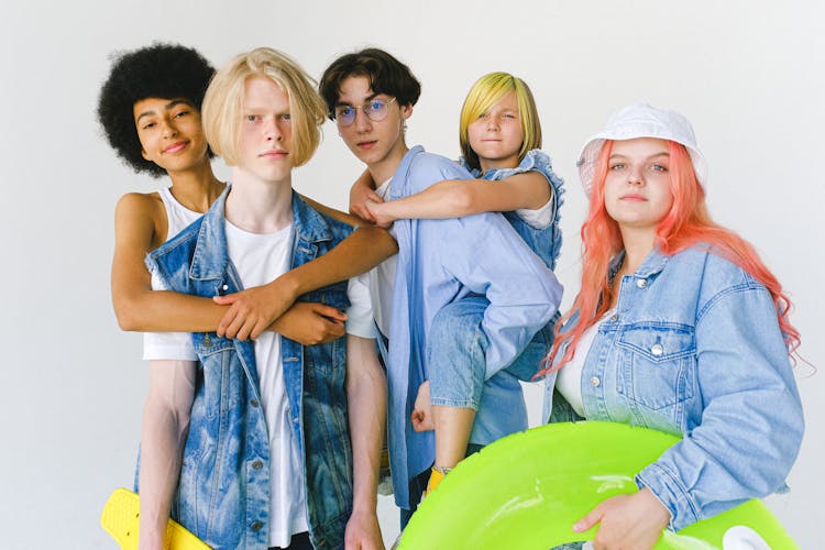 Multiracial Group Of Friends With Longboard And Inflatable Ring