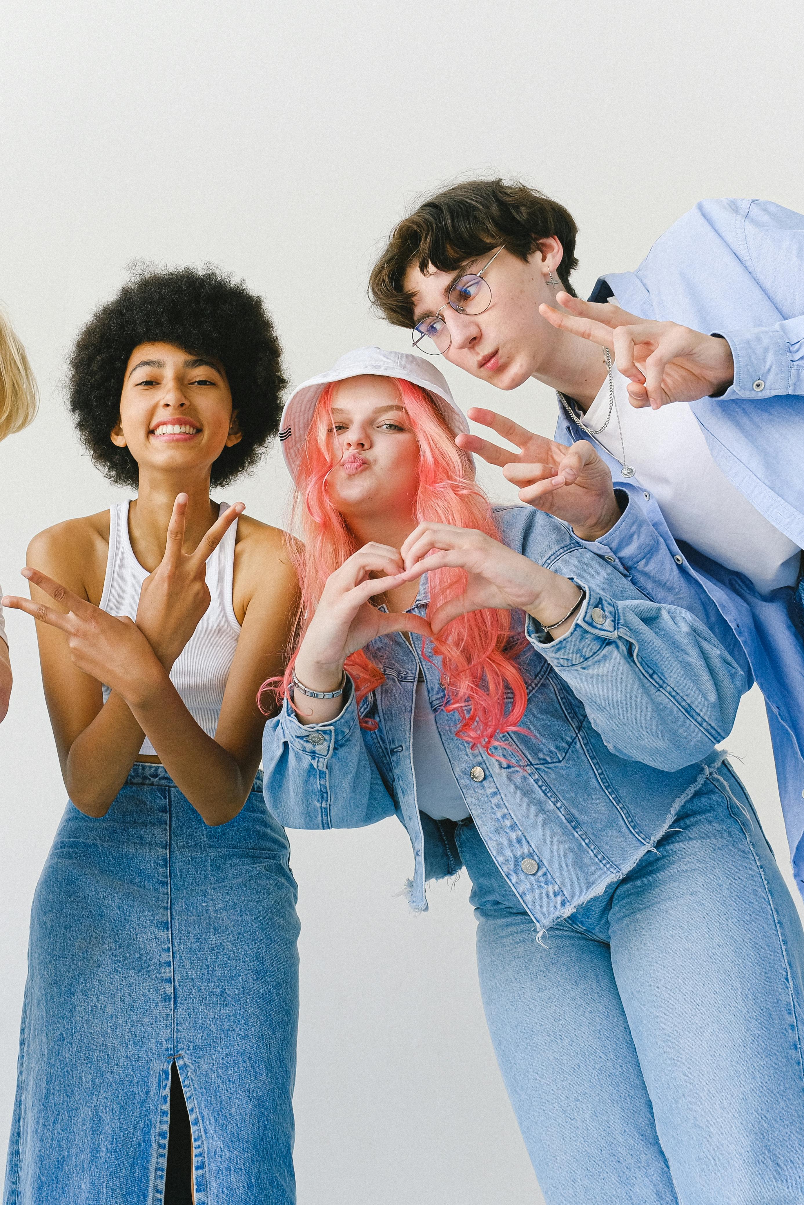 cheerful teenager friends making gestures looking at camera