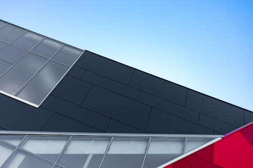 Free Low Angle Photography of Black and Silver Building Stock Photo