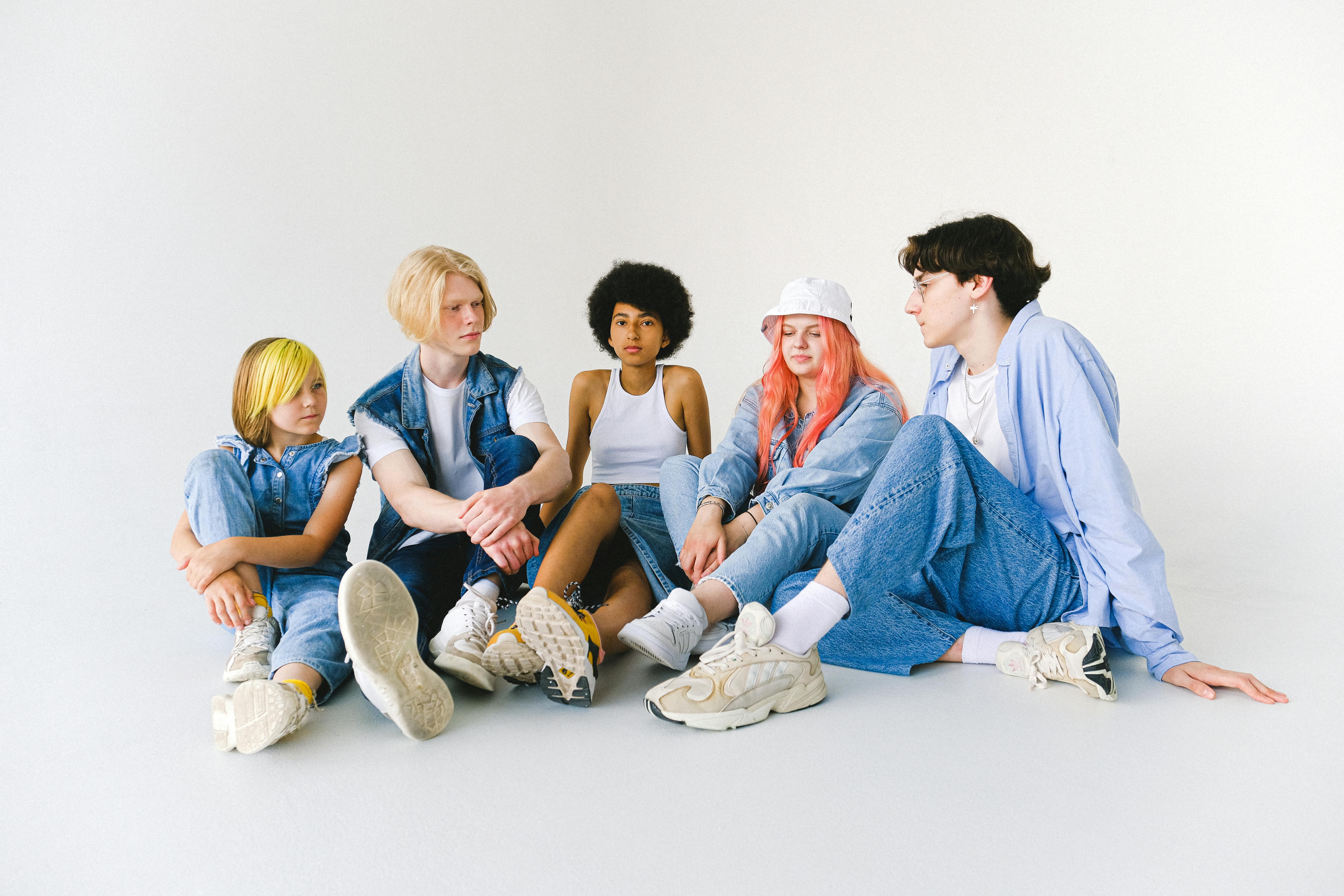 multiethnic friends sitting on floor and talking