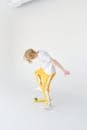 Informal teenager with skateboard on white background