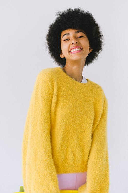 A Woman in Yellow Sweater Smiling