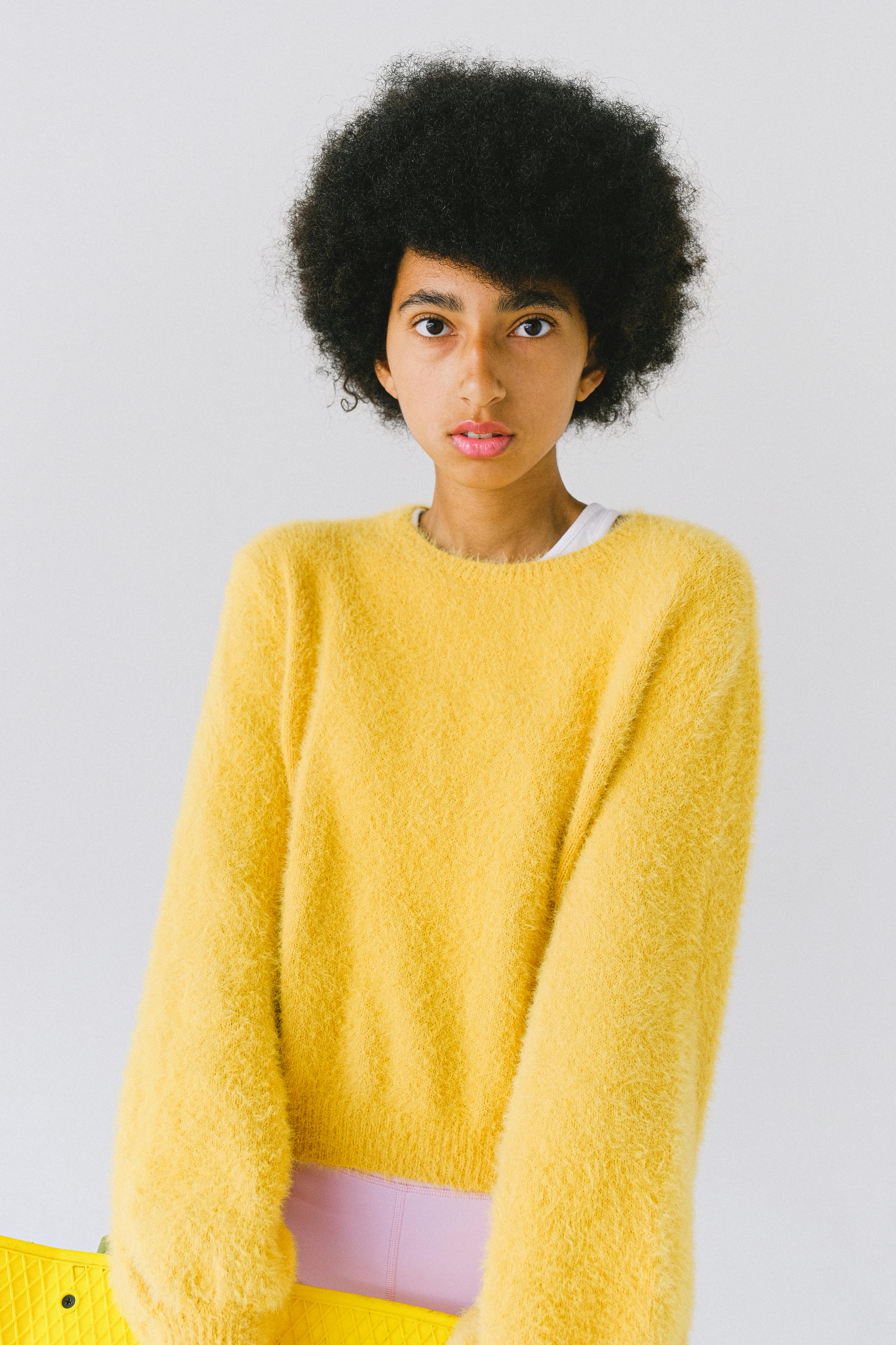 ethnic teen in bright yellow stylish sweater