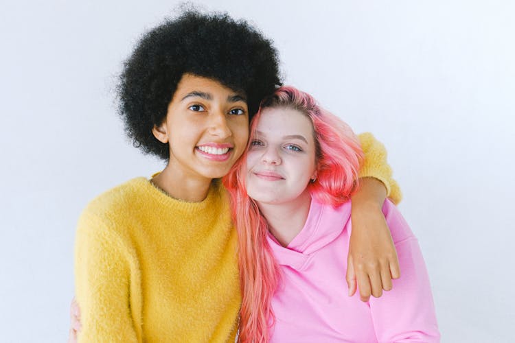 Glad Diverse Teenage Best Friends In Bright Outfit Embracing