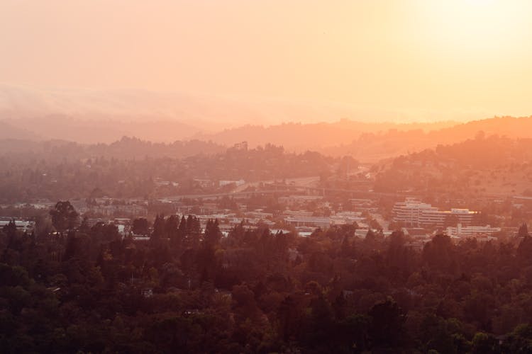 Wonderful Pink Sky Over Town Surrounded By Mountains And Forest