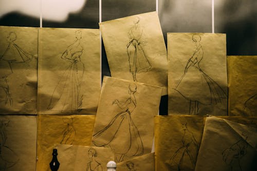 Paper sheets with sketches of historical dresses
