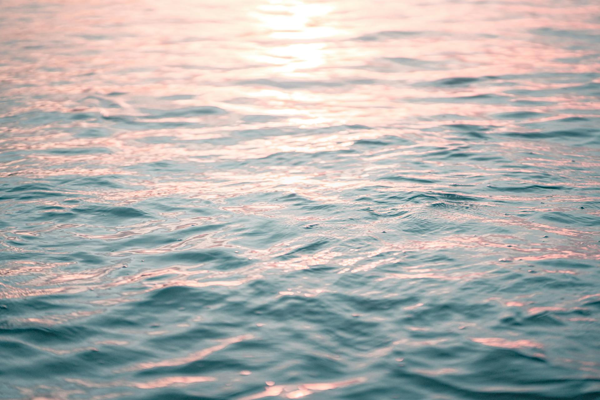 Azure rippling seawater in sunset light