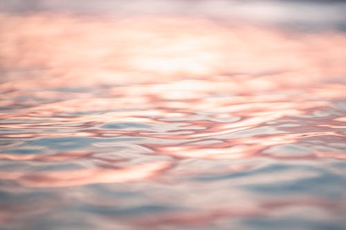 Rippling seawater reflecting pink evening sky