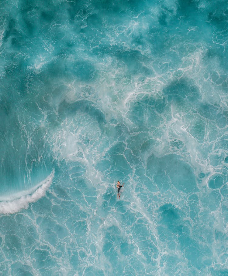 Anonymous Traveler Swimming In Turquoise Ocean During Summer Trip