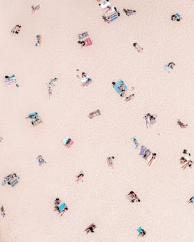 Aerial shot capturing sunbathers at Bondi Beach, showcasing a vibrant summer day.