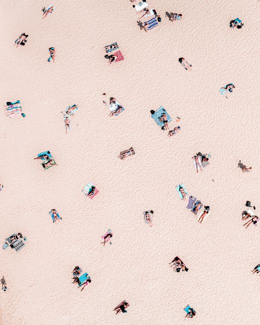 Aerial shot capturing sunbathers at Bondi Beach, showcasing a vibrant summer day.