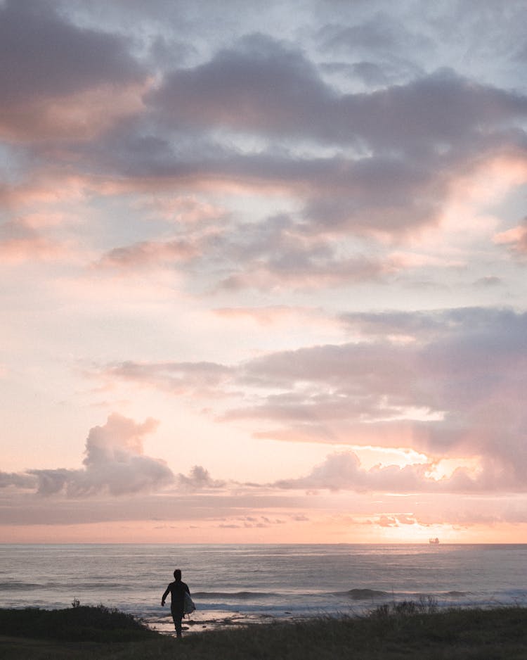 Lonely Person Walking On Beach Against Sea