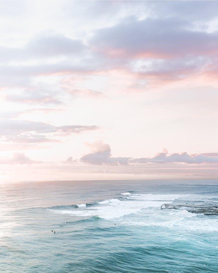 Wavy Sea Under Colorful Sky