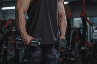 Man in Black Tank Top Holding Black Dumbbell