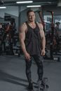 Man in Black Tank Top and Blue Denim Jeans