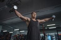 Man in Black Tank Top Holding Gray and Black Dumbbell