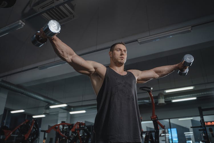 Man In Black Tank Top Holding Silver Dumbbells