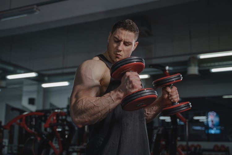 A Bodybuilder Lifting Dumbbells 