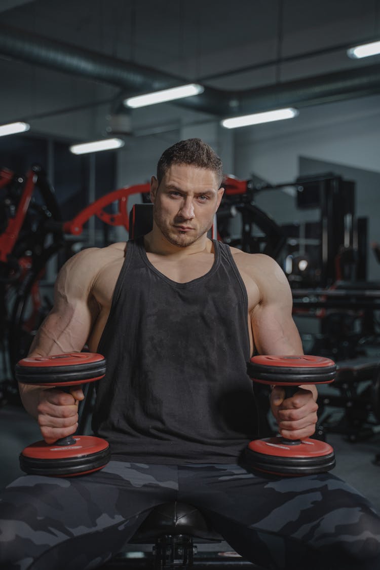 A Man Holding Dumbbells 