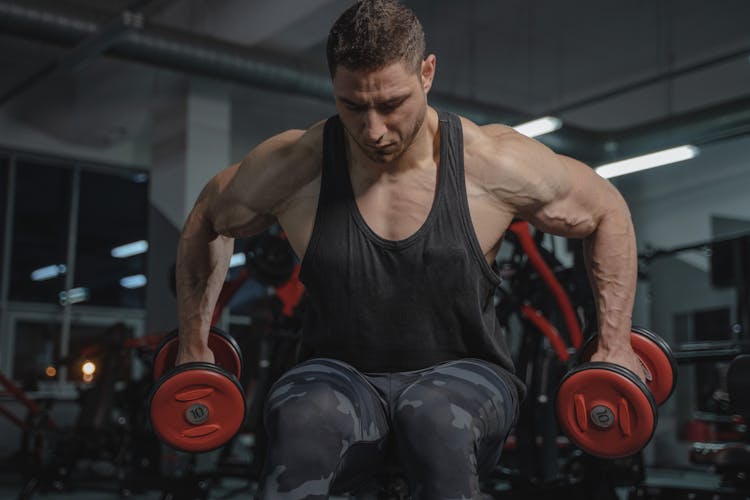 A Man Lifting Dumbbells 