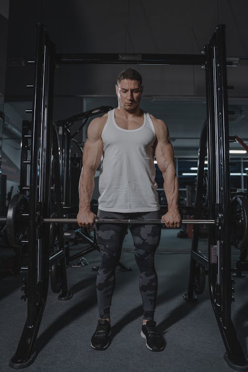 Free A Man Holding a Barbell Stock Photo
