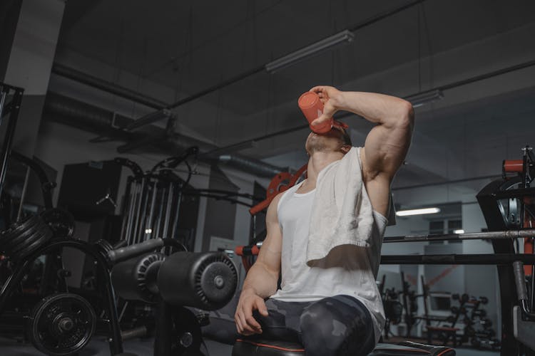 A Man Drinking At The Gym