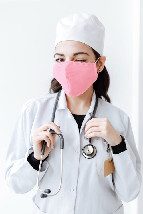 Free Person in White Long Sleeve Shirt With Pink Face Mask Stock Photo